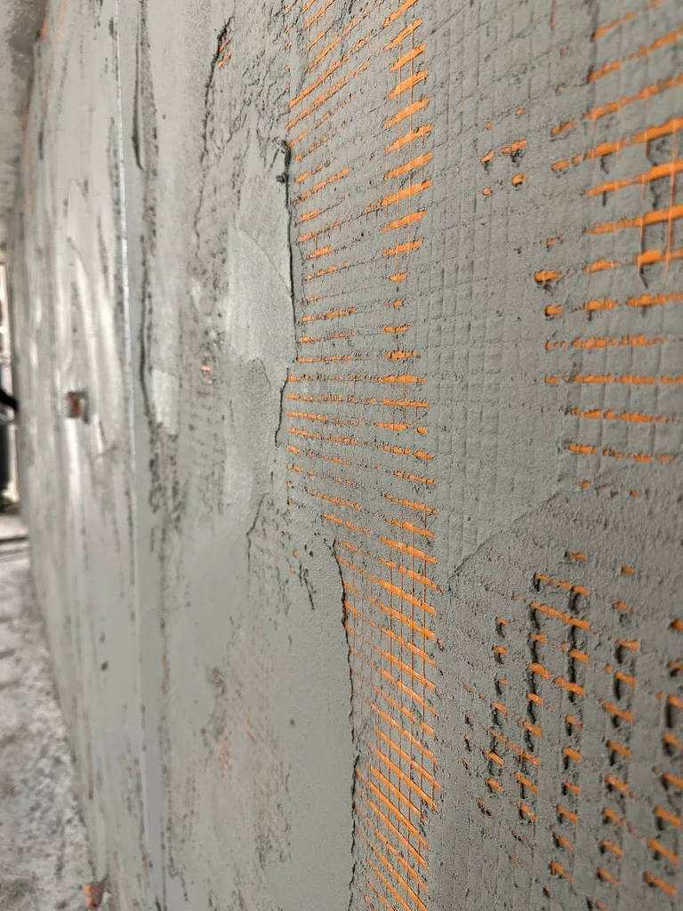 Grundputs armerad med orange glasfibernät från Grigolin
